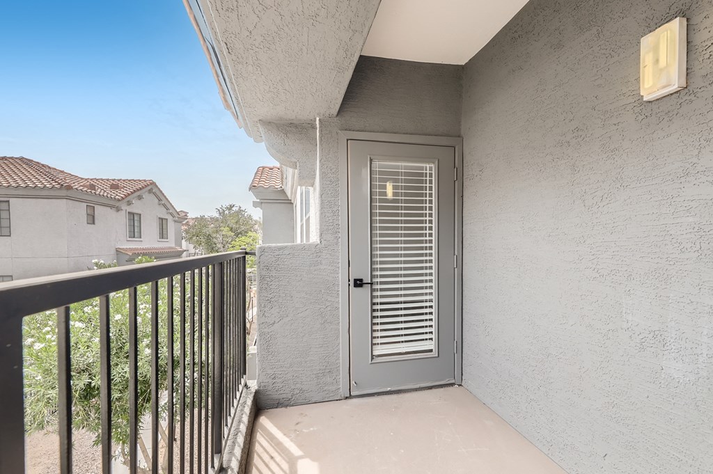 the entrance to the balcony of a condo with a door