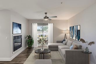 a living room with a couch and a coffee table in front of a fireplace