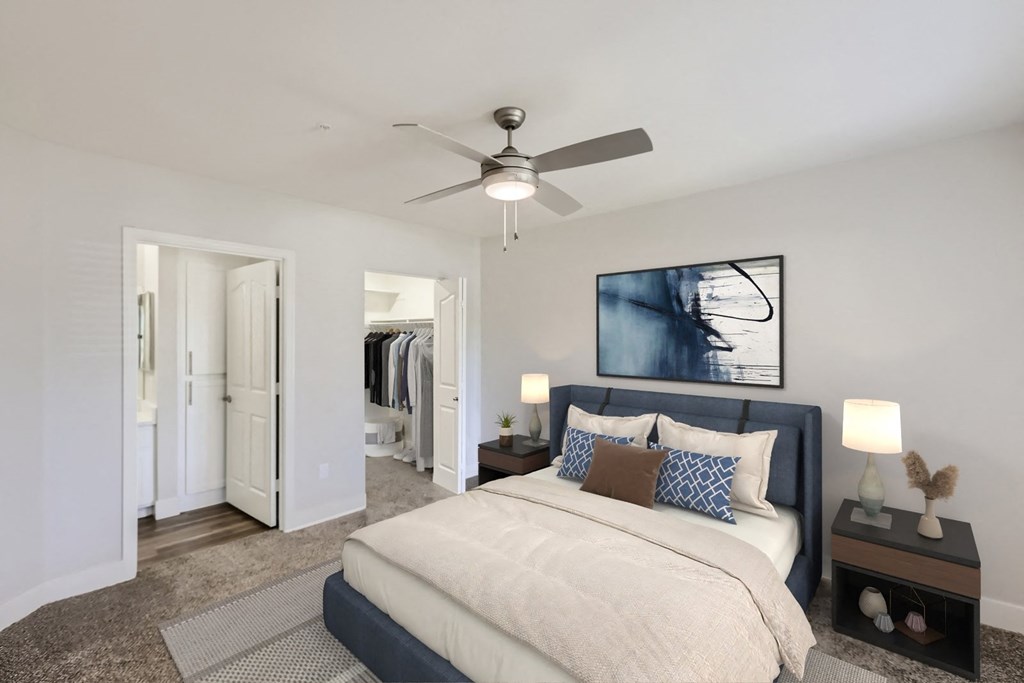 a bedroom with a large bed and a ceiling fan