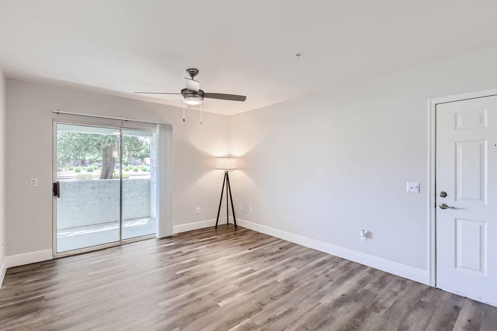 a bedroom with hardwood floors and a ceiling fan