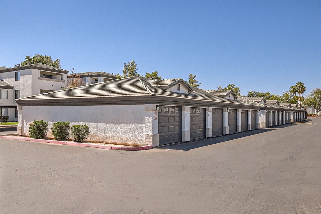 a row of garages with a blue sky in the background