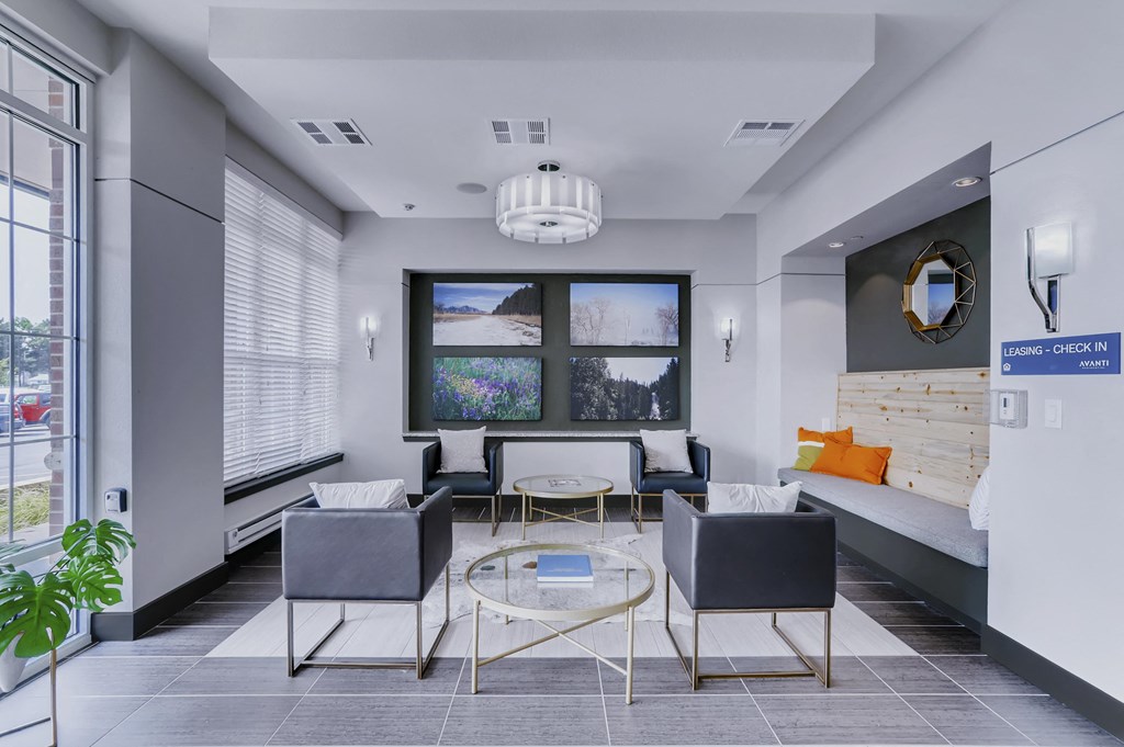 a living room with a couch and chairs and a table