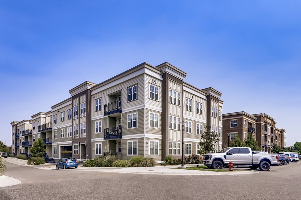 an apartment building with a truck parked in front of it