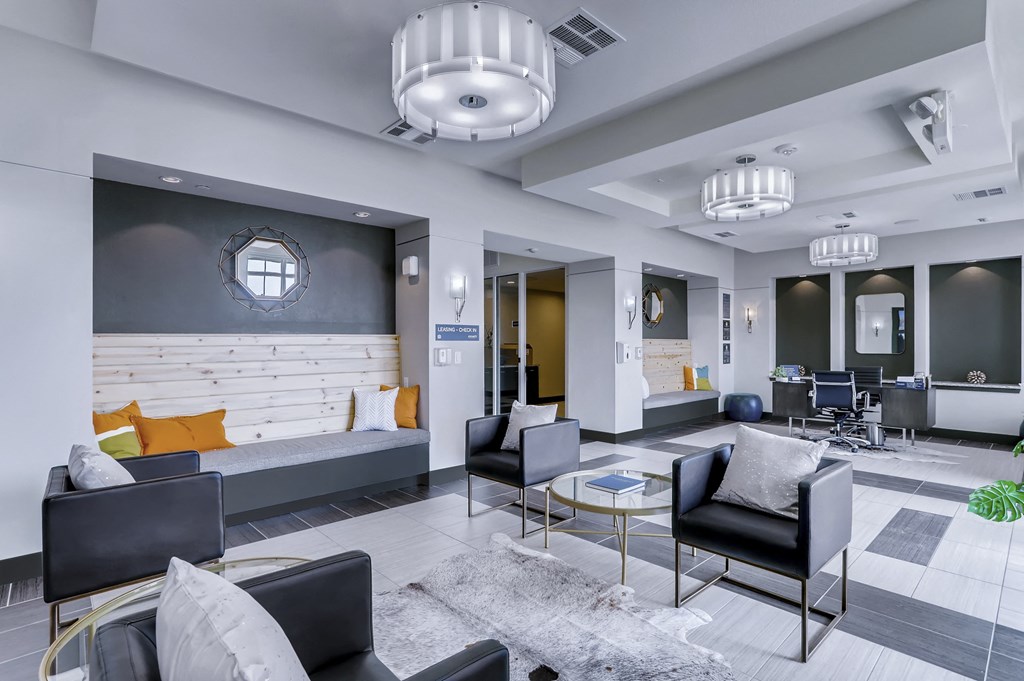 a lobby with chairs and couches and a table