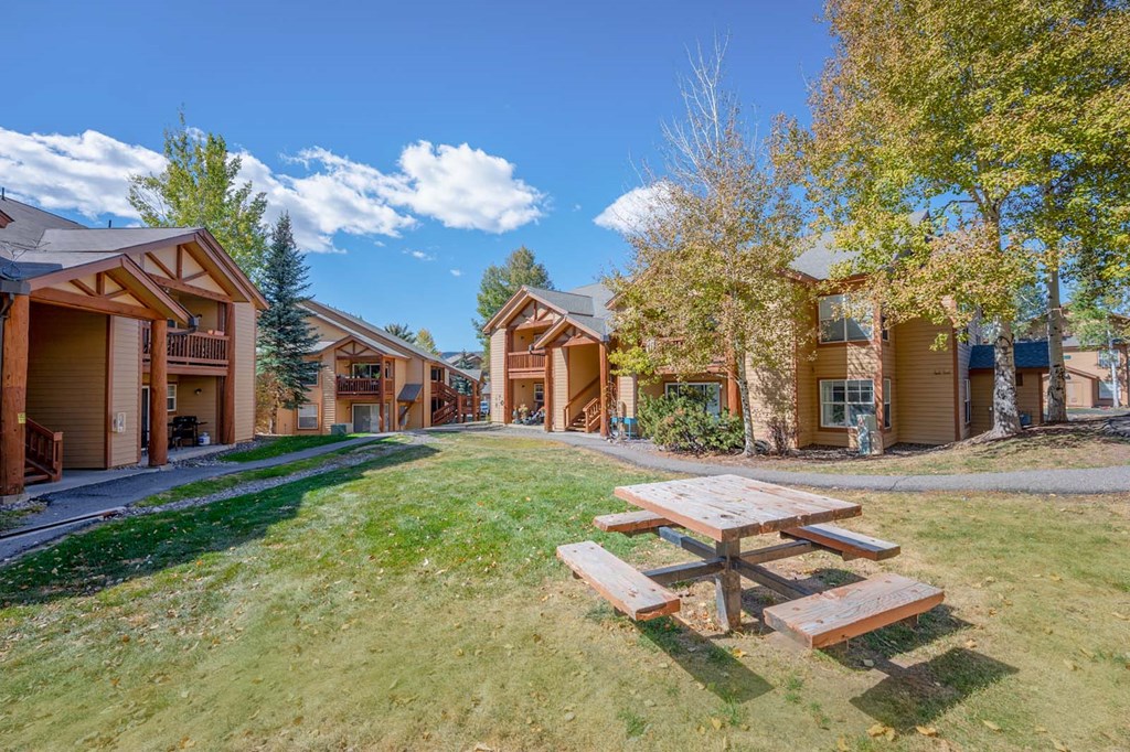 a picnic table in front of a group of buildings