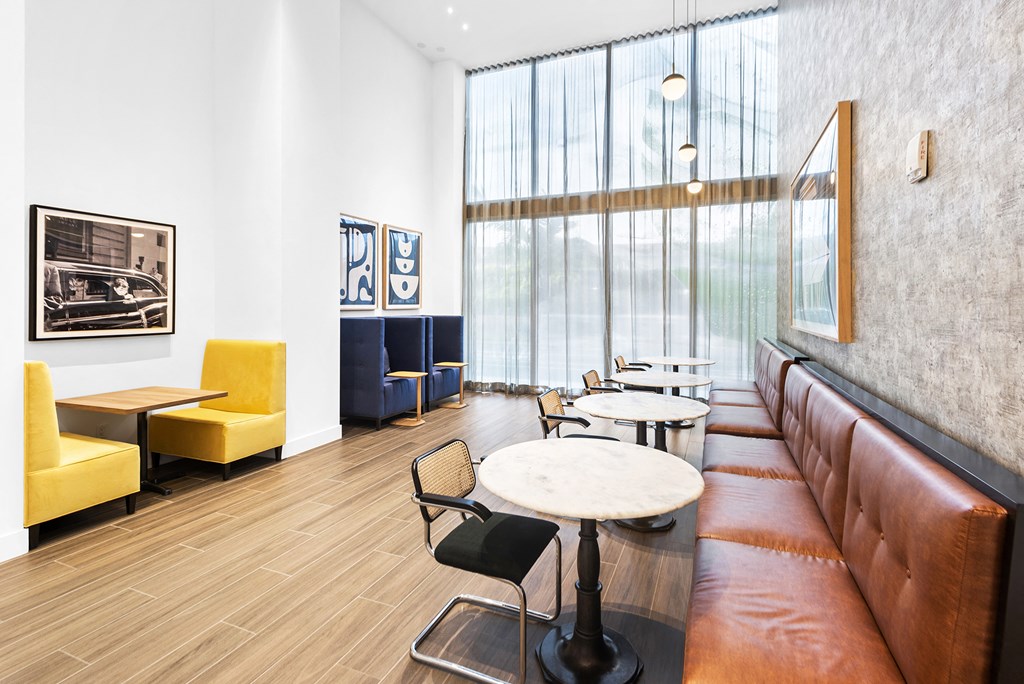 a living room with white walls and a large window