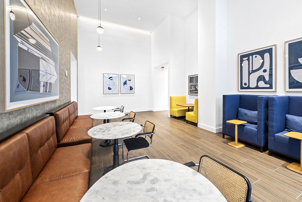 a living room with white walls and blue and yellow furniture