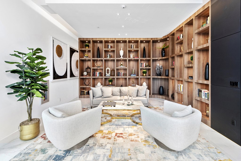 a living room filled with furniture and a large bookshelf