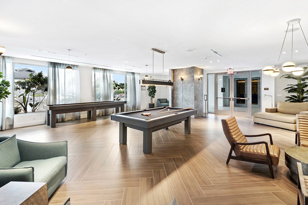 a living room filled with furniture and a pool table