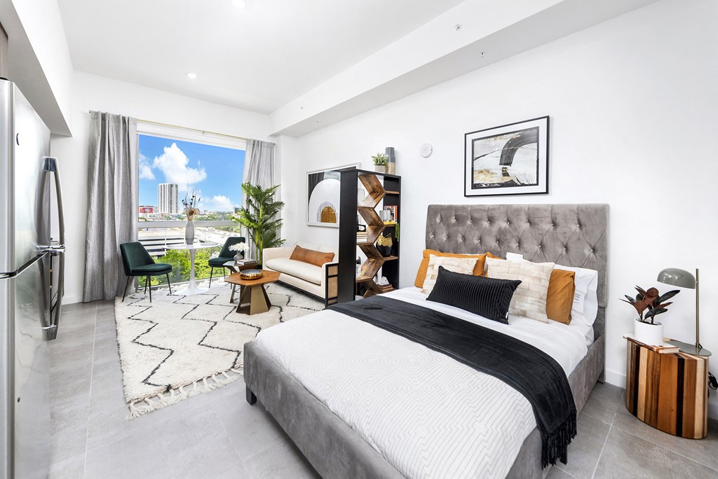 a bedroom with a large bed and a large window