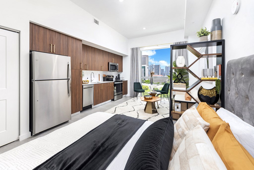 a bedroom with a bed and a desk in a room