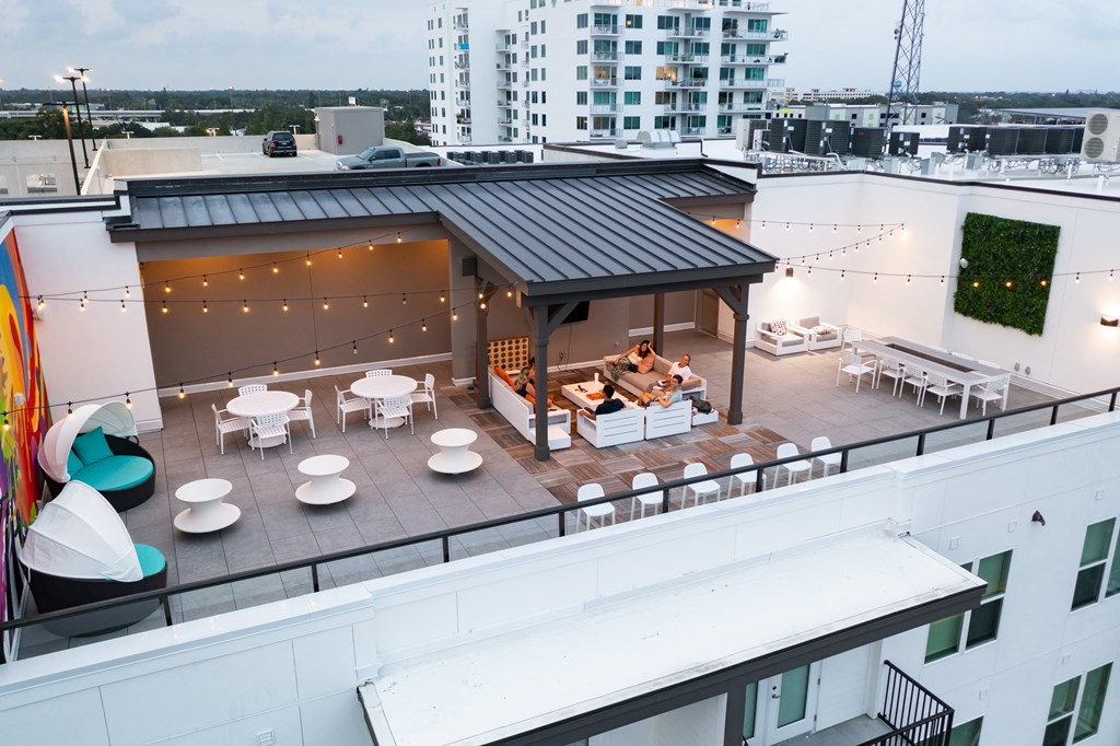 a rooftop patio with tables and chairs and a roof terrace