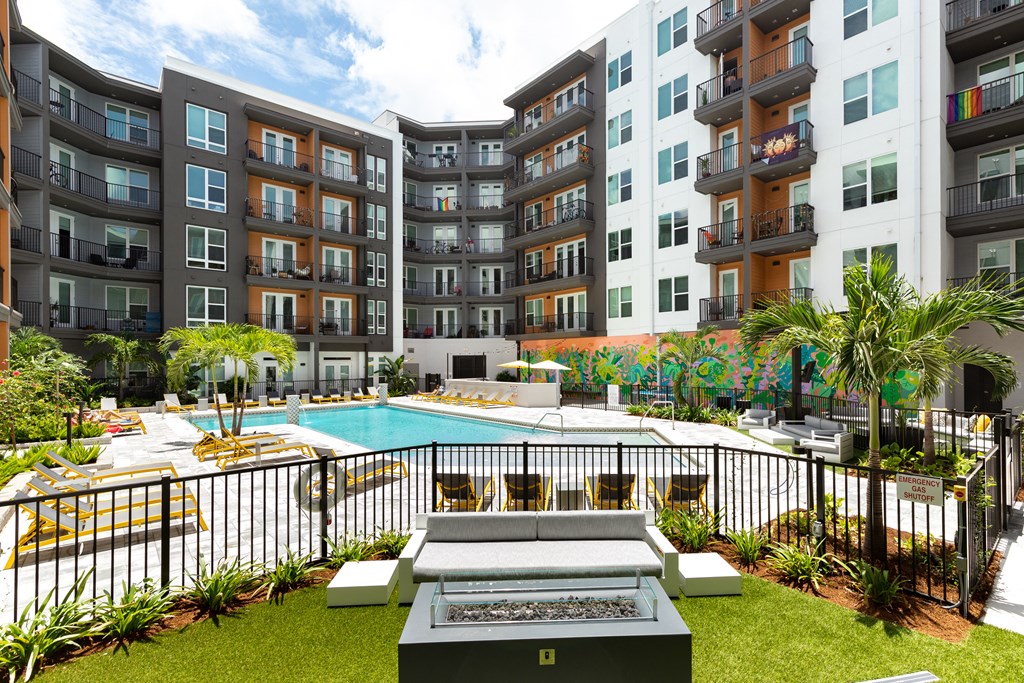 a swimming pool in front of an apartment building