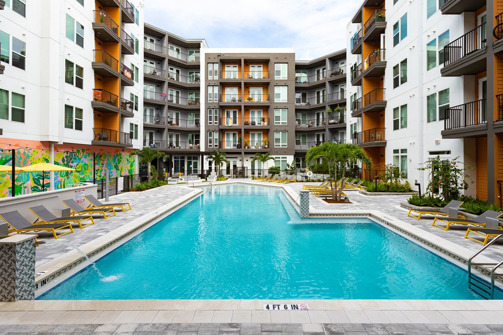 a swimming pool in front of an apartment building