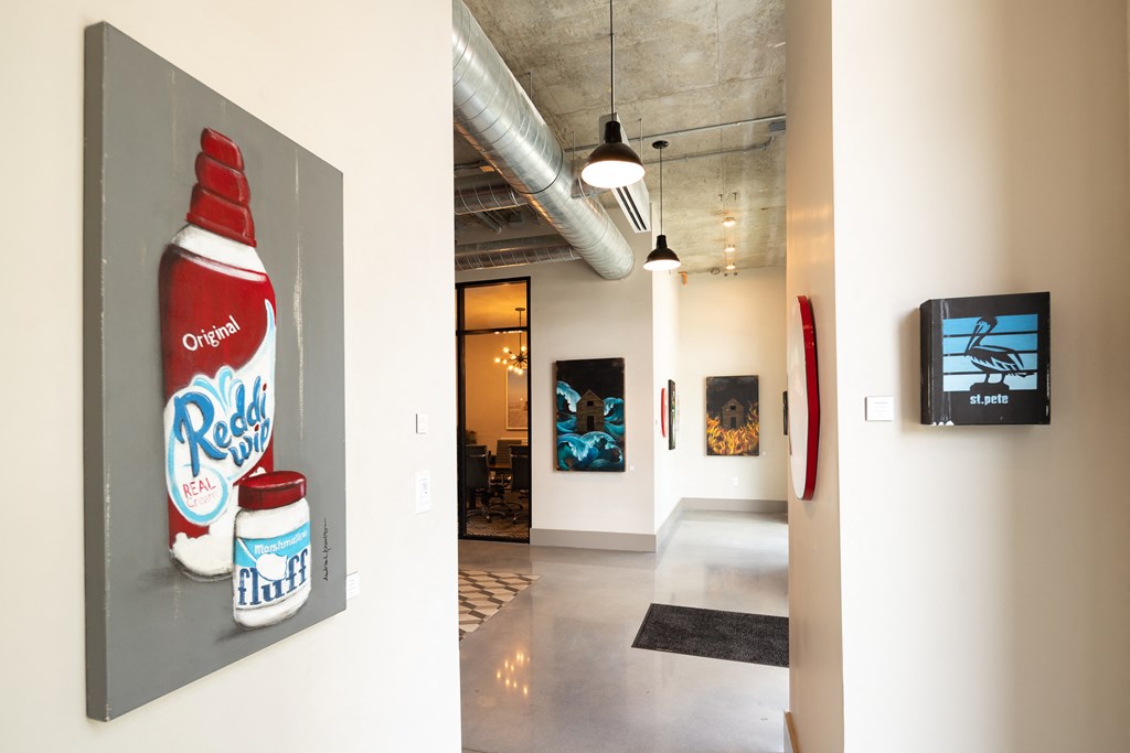 a painting of a bottle of soda on a wall in a hallway