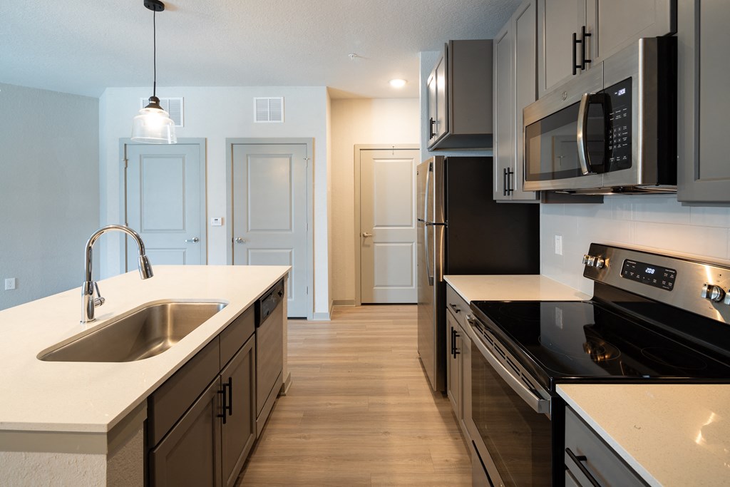a kitchen with black appliances and white counter tops