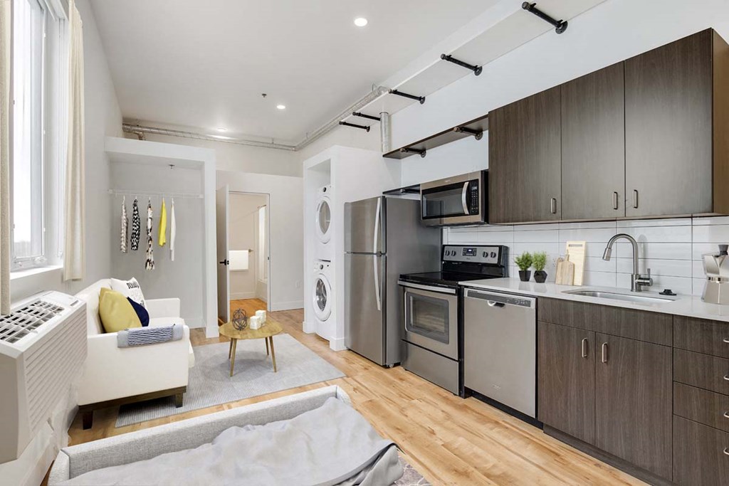 a kitchen with stainless steel appliances and a living room