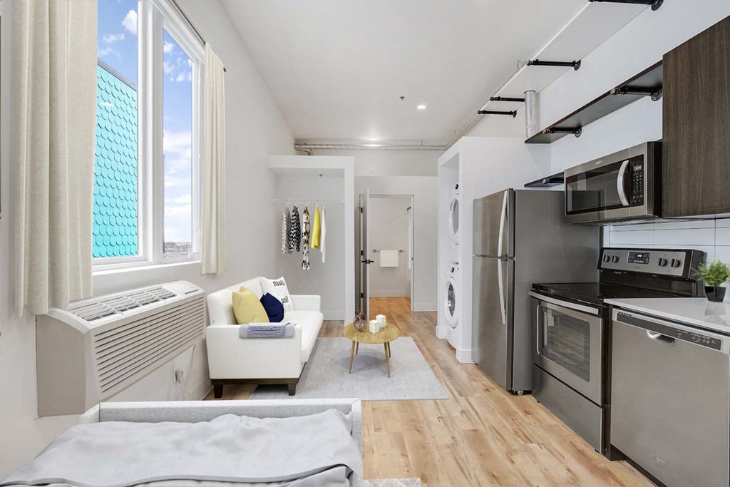 a kitchen and living room with a stove and a refrigerator