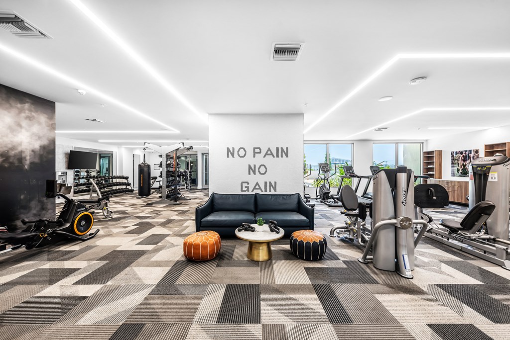 a workout room with a large sign that says no pain no gain
