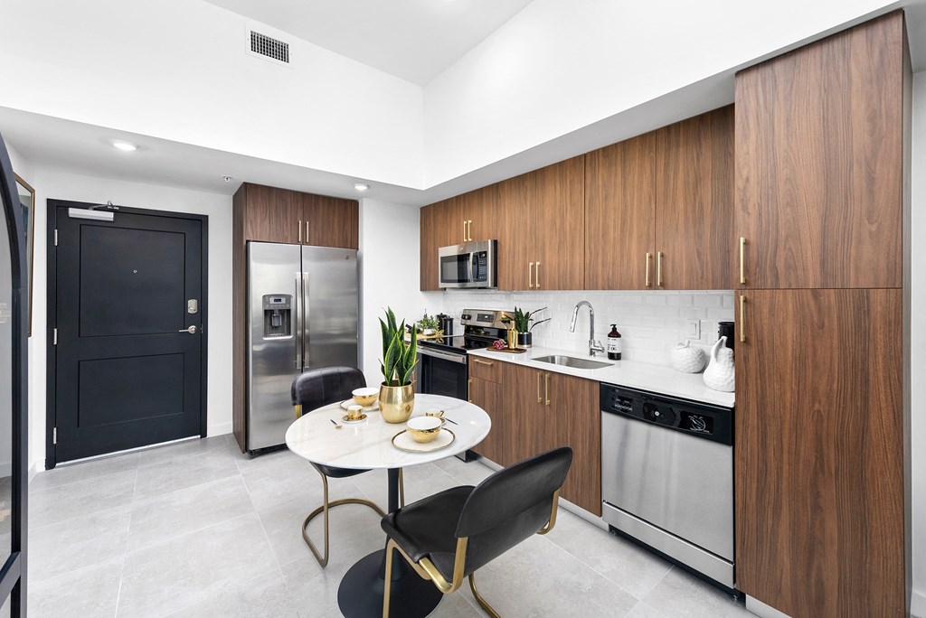 a kitchen with wooden cabinets and stainless steel appliances