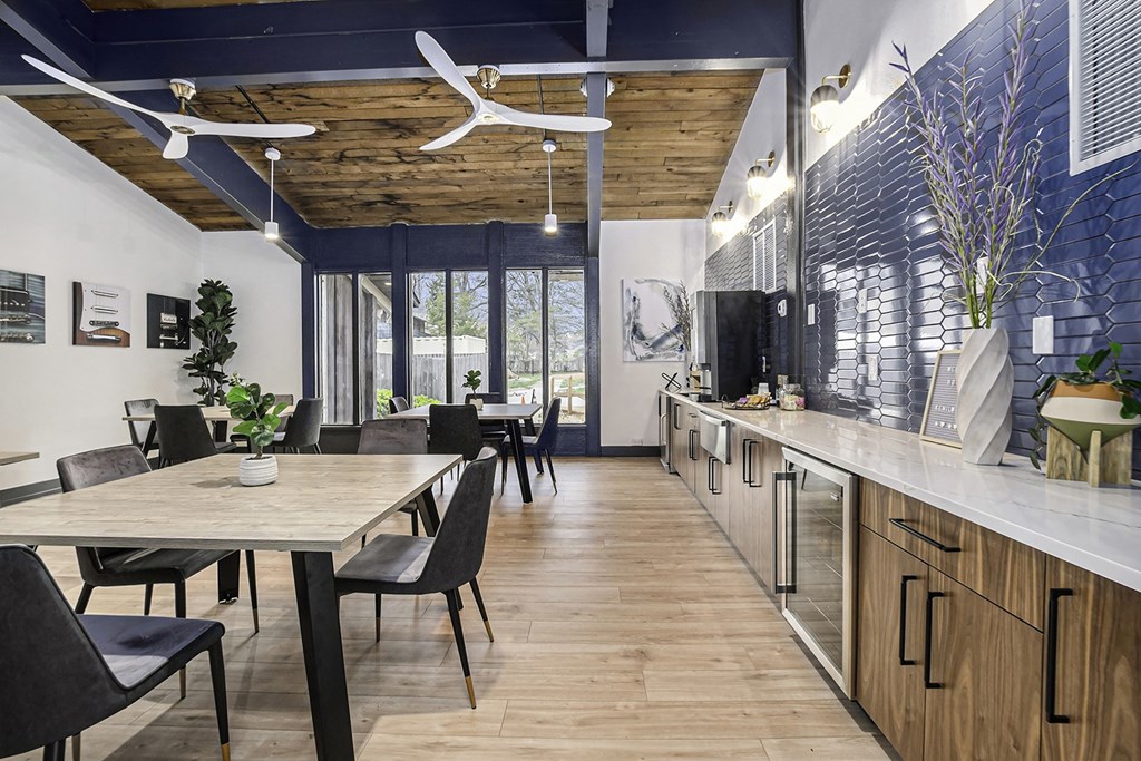 a kitchen and dining room with blue and white walls and wood floors