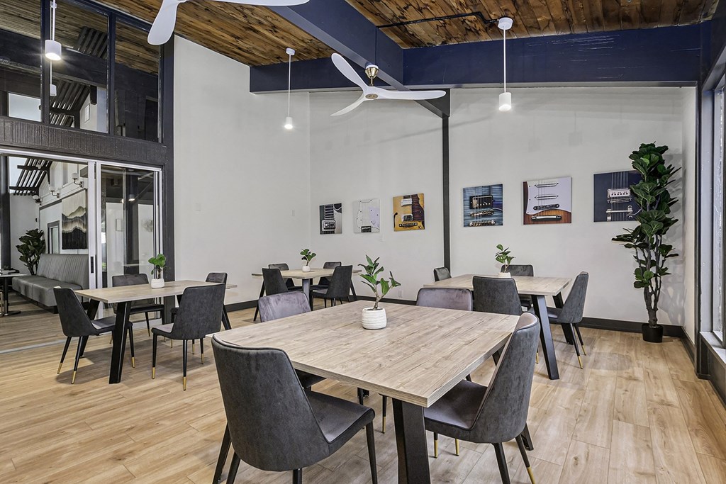 a dining room with tables and chairs and a ceiling fan