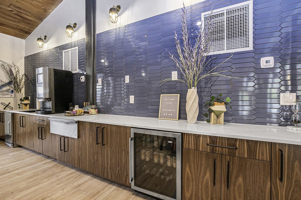 a kitchen with a counter and a blue tile wall