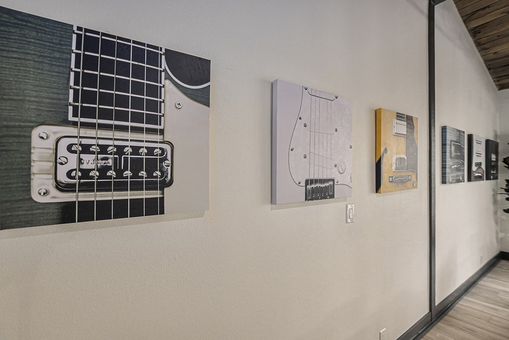 a wall with several pieces of art on it