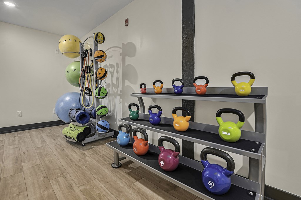a fitness room with weights and other exercise equipment