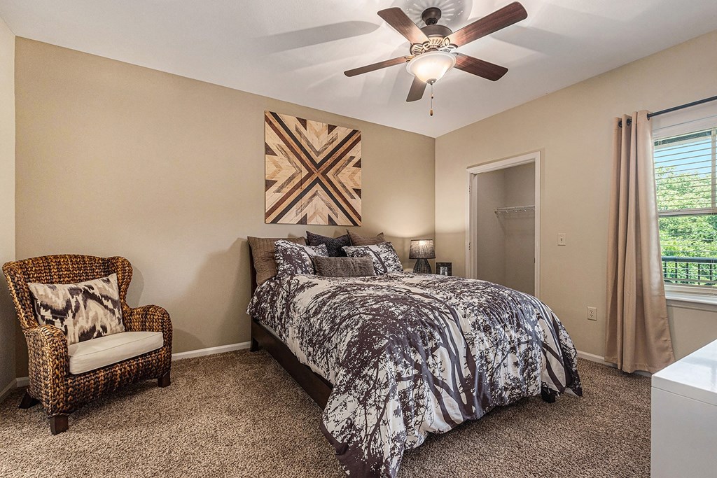 a bedroom with a bed and a ceiling fan