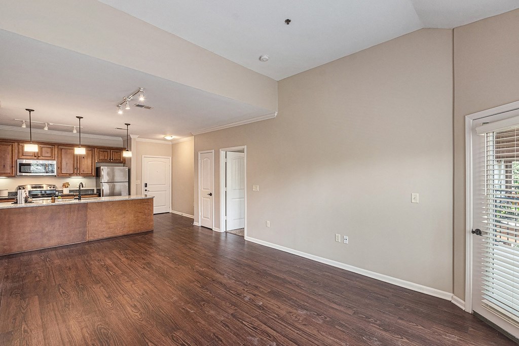 a kitchen and living room with hardwood floors
