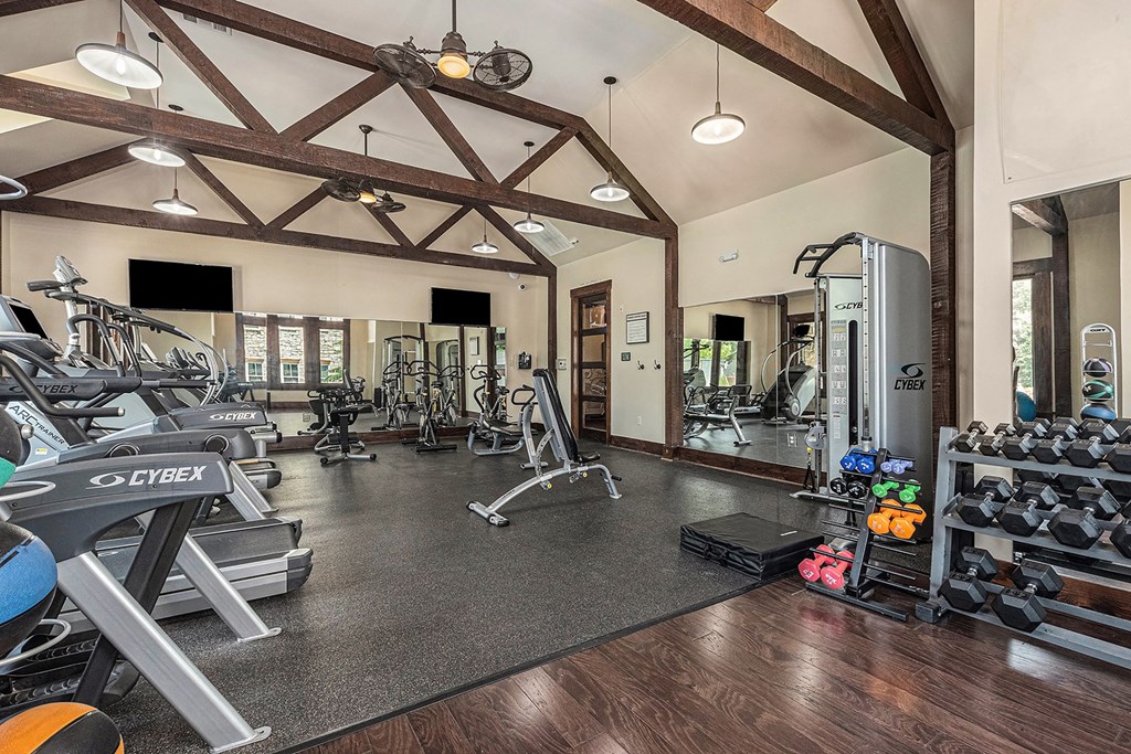 a gym with cardio equipment and weights
