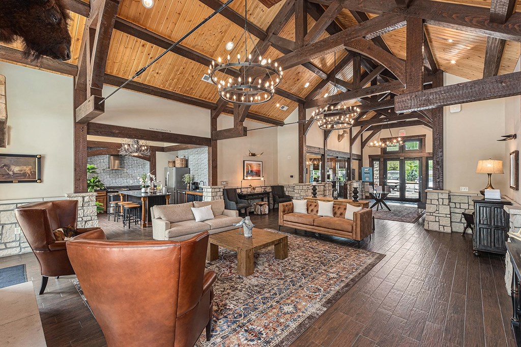a living room filled with furniture and a large chandelier
