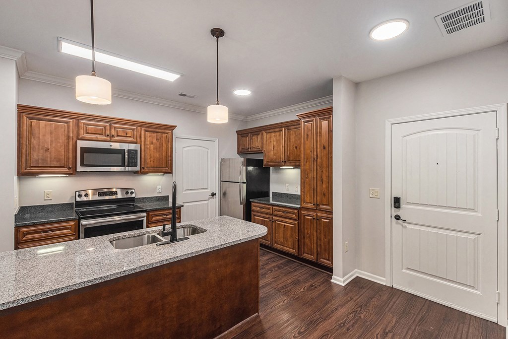 a kitchen with wooden cabinets and a granite counter top