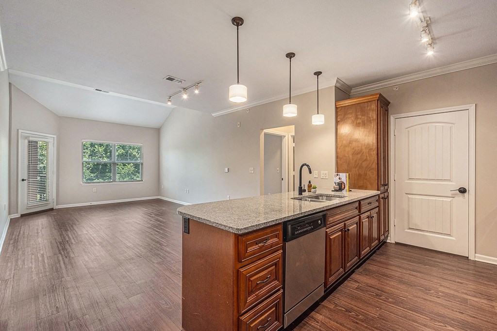 a kitchen and living room with hardwood floors