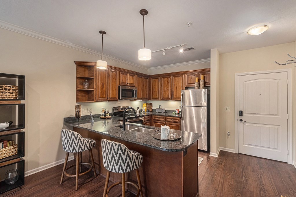 a kitchen with an island and three stools