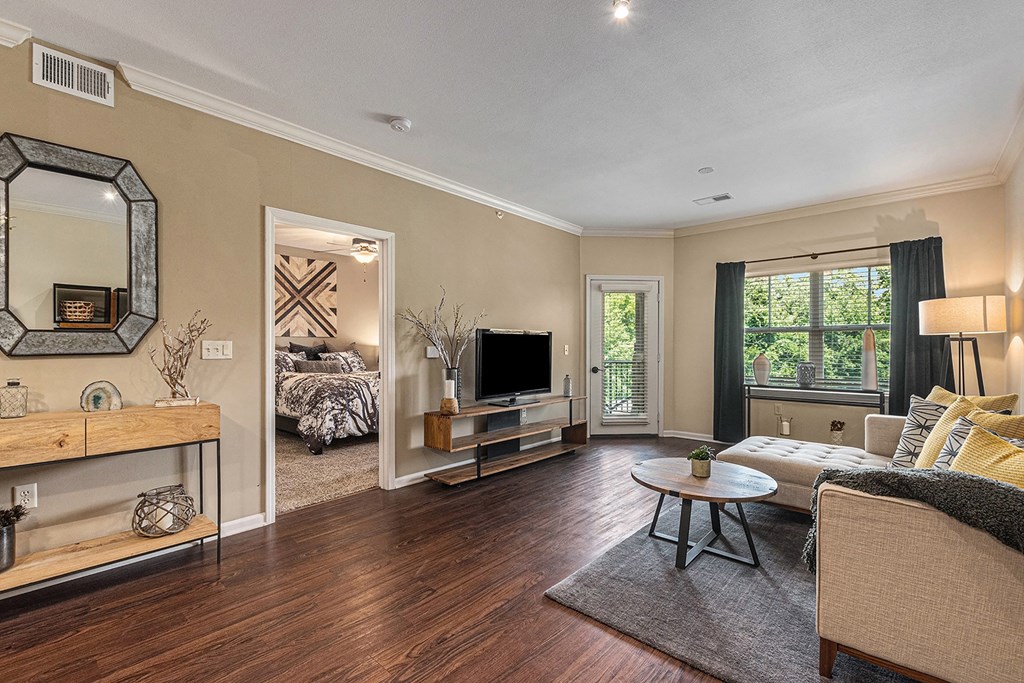 a living room with hardwood floors and beige walls