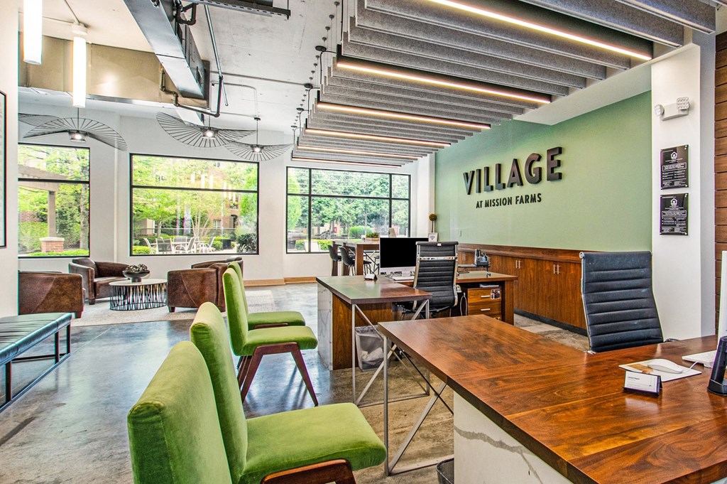 a large office with green chairs and a desk with a computer