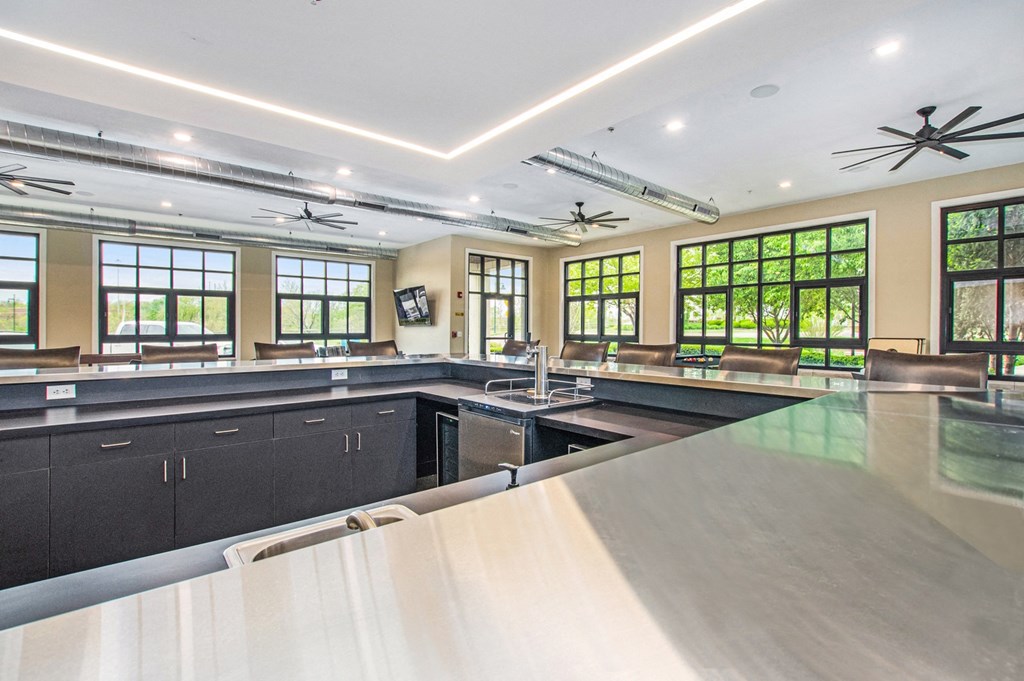 a large kitchen with a sink and a counter top