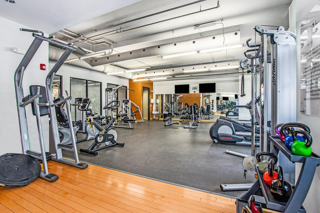a gym with weights and other exercise equipment in a large room