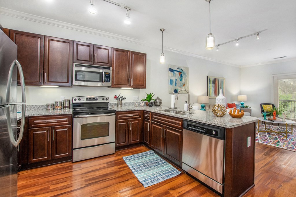 a kitchen with wooden cabinets and stainless steel appliances