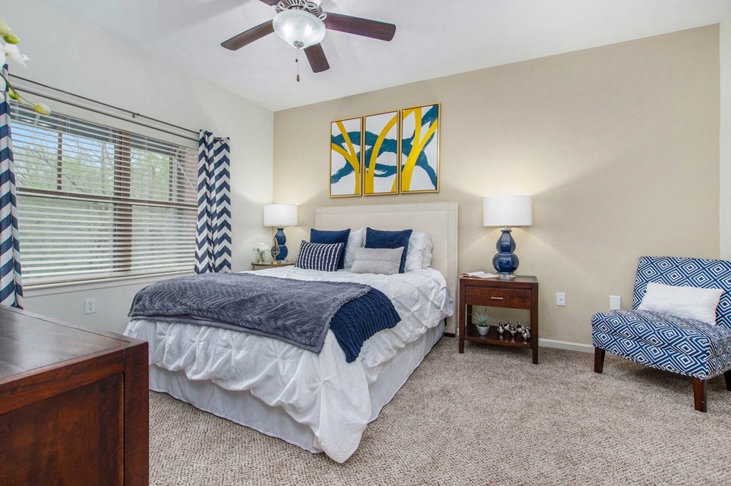 a bedroom with a bed and a ceiling fan