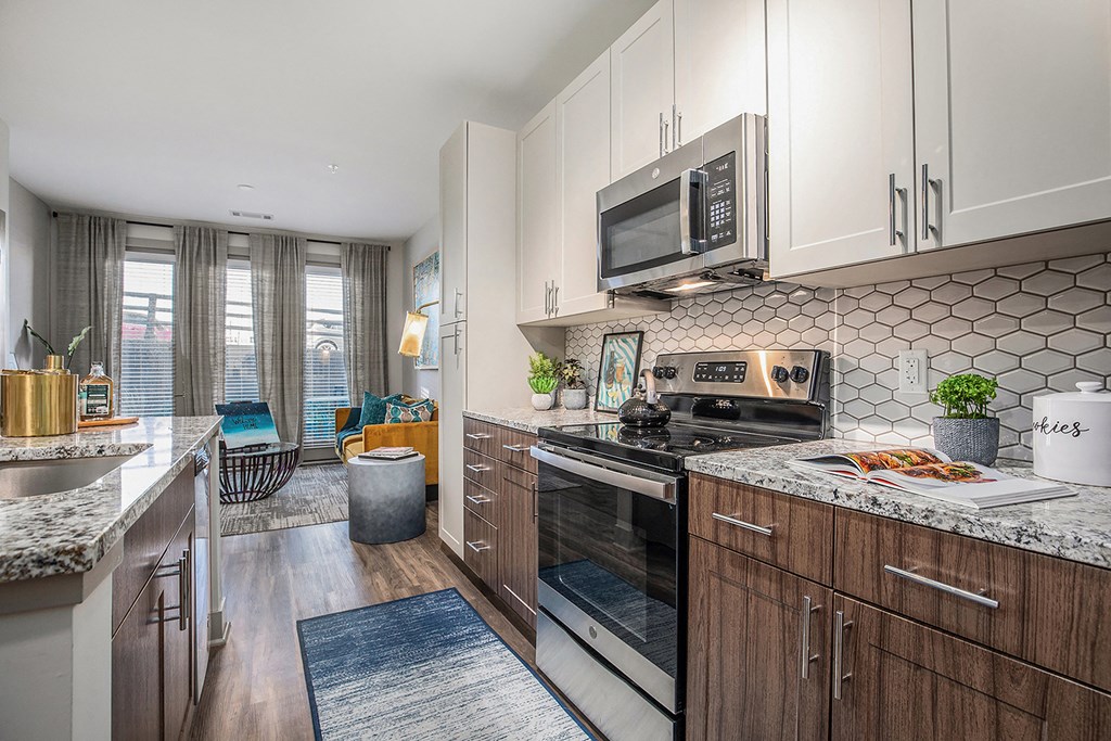 a kitchen with white cabinets and a stove and a microwave