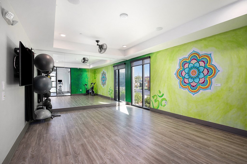 a large room with a large green wall and a large mural on the side of