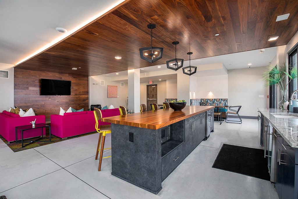 a kitchen with a large island and a dining room with a table and chairs