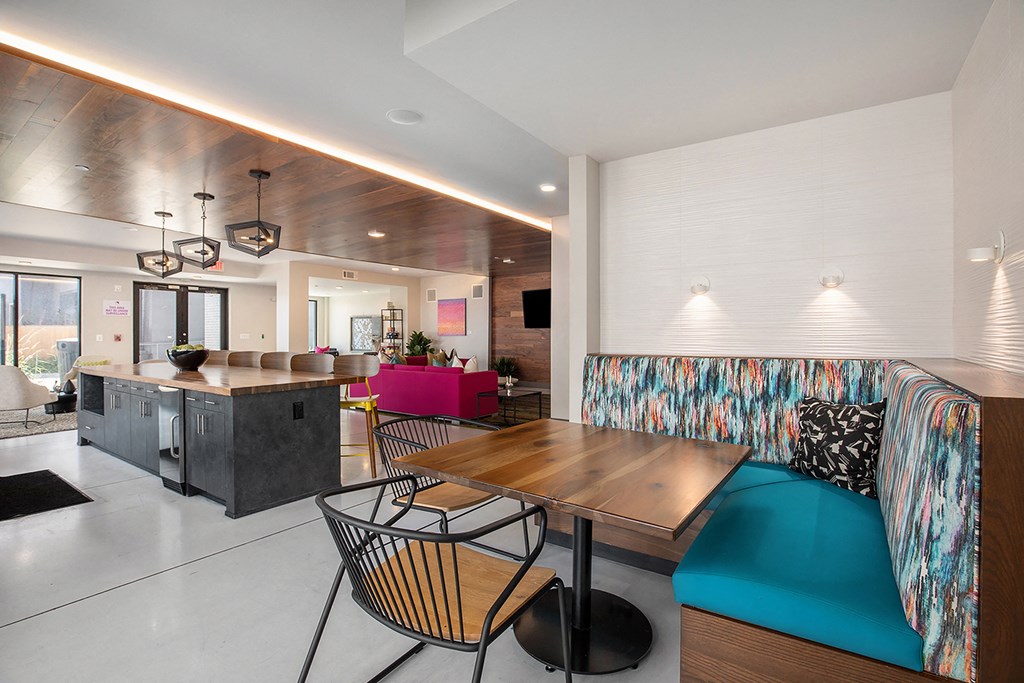 a living room and dining room with a table and chairs