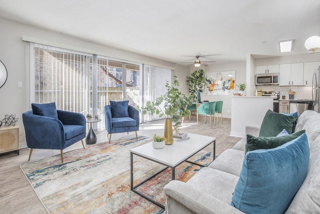 a living room with couches and chairs and a table
