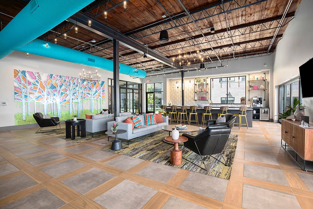 a large lobby with furniture and a large mural on the wall