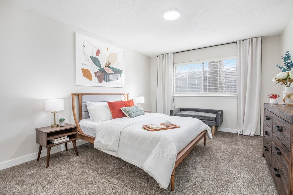 a bedroom with a bed and a window