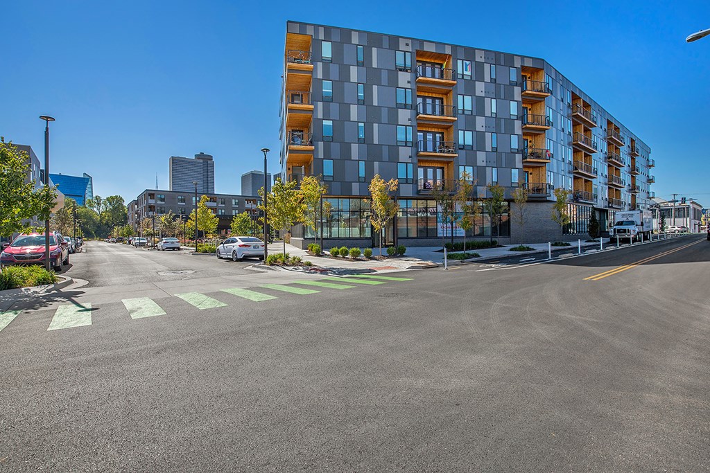 an empty street with an apartment building in the background